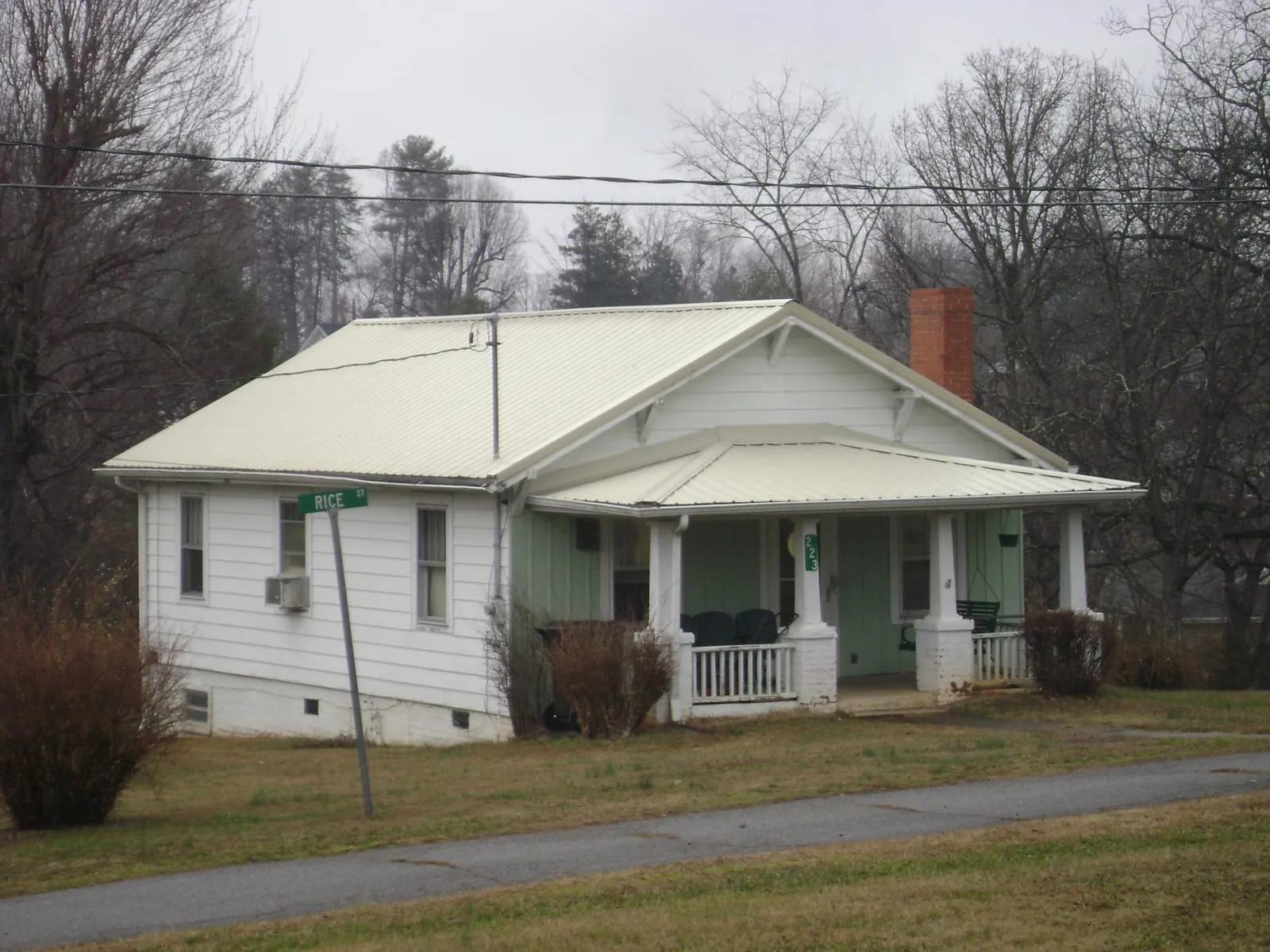 White metal roof on a craftsman bungalow at a street corner in Carey